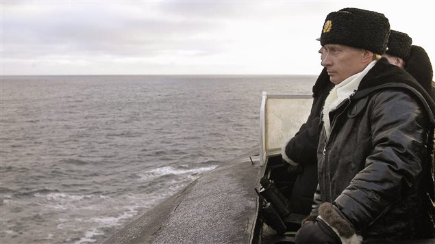  Russian President Vladimir Putin observes from aboard the submarine *Archangelsk* during exercises in the Barents sea near Severomorsk February 17, 2004. 