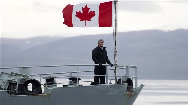  Former Canadian Prime Minister Stephen Harper stands on the bow of the HMCS Kingston as it sails in the Navy Board Inlet Sunday August 24, 2014.