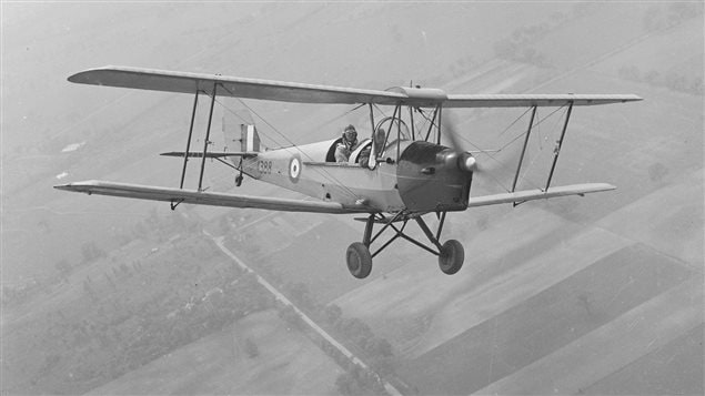 A Tiger Moth flies out of No. 1 Elementary Flight Training School at RCAF Malton, Ontario. Almost all of the pilots under the British Commonwealth Air Training Plan in Canada began their flight training on Tiger Moths