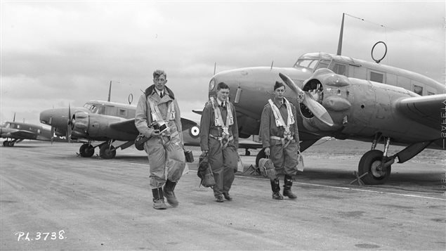 Observers from Australia, Canada and Great Britain walk to their Avro Anson aircraft for navigation training at RCAF Rivers, Manitoba. Twin Engine planes were used for training of bomber pilots, and navigators.