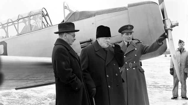 British Prime Minister Winston Churchill (centre) visits the British Commonwealth Air Training Plan school at RCAF Uplands, Ontario, in December 1941 with Canadian Air Minister C.G. Power (left) and Wing Commander W.R. MacBrien. 