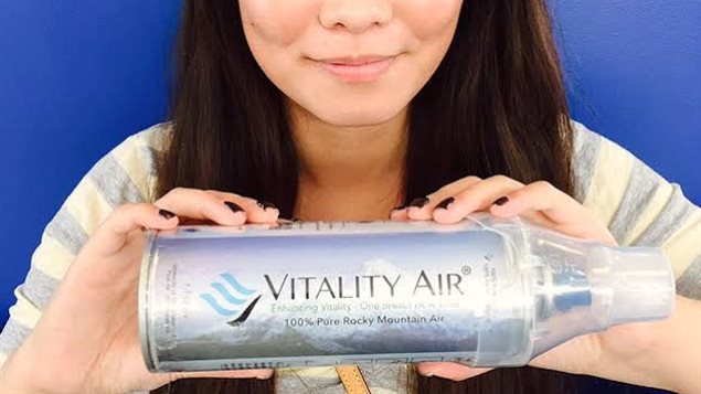 Vitality Air model, Hannah Lam, holds a can filled with air that the compay says was collected directly from Banff, Alta. (Vitality Air