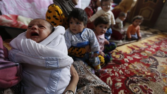 This baby and his family have moved ten times since fleeing their homes in Aleppo, Syria. They now share a small room in rural Damascus.