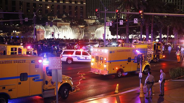  Police and emergency crews respond to the scene of an incident along Las Vegas Boulevard, Sunday, Dec. 20, 2015, in Las Vegas. A woman intentionally swerved her car onto a busy sidewalk two or three times Sunday and mowed down people outside a casino, killing one person and injuring at least 30 others, police said.