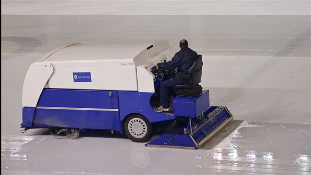 Although there are several different companies making the machnices, they’re all generally referred to as the *Zamboni* . They clean off loose snow as the result of skates and lay down a thin layer of water which fills in the small gouges and freezes to create a smooth surface.