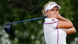 Brooke Henderson was The Canadian Press female athlete of the year. We see her completing a swing the her driver back over her left shoulder. She is attractive and blond and her face really does show that she is just 18.