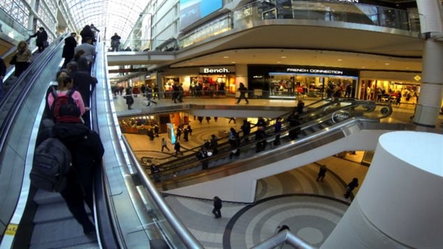 Mounting debt doesn't appear to be keeping a lot of people away from the malls. We see a very, very fancy mall with people riding on a series of escalators. The overall feeling is space age.