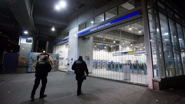  Transit security officers walk outside the Commercial-Broadway Skytrain station after the commuter train system was shut down to check for any possible damage to elevated guideways in Vancouver, B.C., in the early morning hours of Wednesday December 30, 2015, after an earthquake struck off the west coast late Tuesday night.