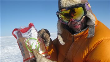 York professor and Arctic scientist William Colgan holds two bottles of whisky which had frozen solid in the extreme cold.