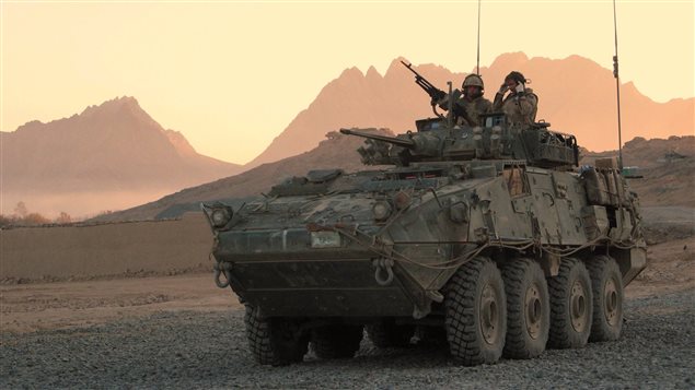  A Canadian LAV (light armoured vehicle) arrives to escort a convoy at a forward operating base near Panjwaii, Afghanistan at sunrise on Nov.26, 2006.