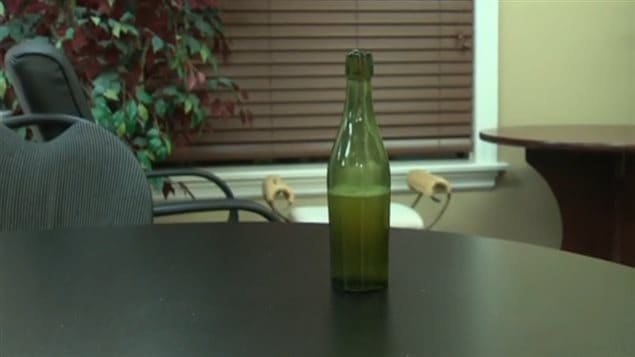 The half full bottle containing beer about 125 years old