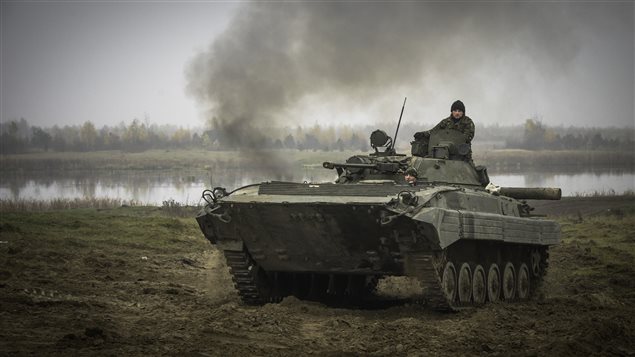  Ukrainian soldiers manoeuvre a BMP-2 armoured vehicle on a live range at the International Peacekeeping and Security Centre (IPSC) during Operation UNIFIER in Starychi, Ukraine on November 6, 2015.