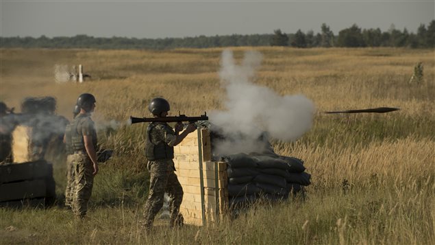  A member of the Ukrainian Forces fires a grenade launcher on a firing range during Operation UNIFIER at the International Peacekeeping and Security Centre (IPSC) in Starychi, Ukraine, on September 16, 2015.