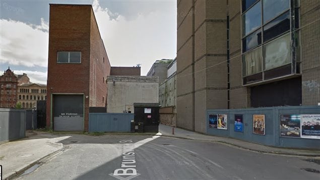 The light coloured wall of the two story building in Brunswick Lane is believed to be the birthplace of Sir John A Macdonald.  At the time it would have been a three story building and site of the Macdonald home and textile shop.  For decades afterward it was a pub under various owners but in recent years had been left abandoned. This google imatge is dated August 2015. It was slated to be demolished (and may be by now) as part of a major downtown rejuvenation.