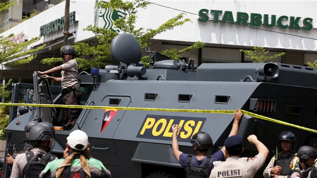 A police armoured personnel carrier is seen parked near the scene of an attack in central Jakarta January 14, 2016. Militants launched a gun and bomb assault in the center of the Indonesian capital on Thursday, killing at least six people, in an attack that followed a threat by Islamic State fighters to put the country in their *spotlight,* police said.