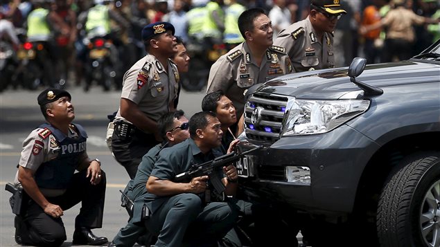  Police officers react near the site of a blast in Jakarta, Indonesia, January 14, 2016. Several explosions went off and gunfire broke out in the centre of the Indonesian capital on Thursday and police said they suspected a suicide bomber was responsible for at least one the blasts.