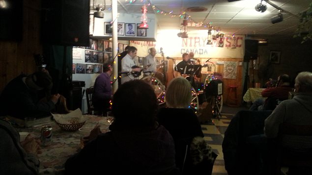 A group of regulars from the backup band on the small area set aside for the *stage*