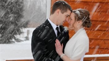 The snow had already started when Jeremy Landry and his bride Sarah Isherwood posed for a photo before their wedding reception.