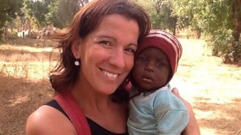 Maude Carrier was with her parents and brother in Burkina Faso when she posed for a photo with a local child. 