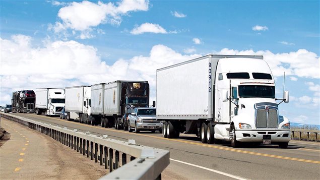  Trucks hauling cargo from Canada through the United States to Mexico make their way to Wyoming Highway 30 on Tuesday, April 21, 2015, in Laramie, Wyo.