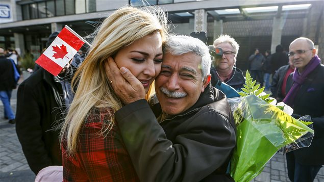  Maria Karageozian is reunited with her father Hagop, a Syrian refugee who arrived earlier in the morning at the Armenian Community Centre of Toronto in Toronto, December 11, 2015.