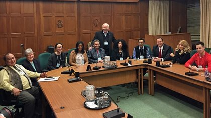 CBC anchor Peter Mansbridge (standing) greets 10 Canadians selected for individual meetings with the prime minister.