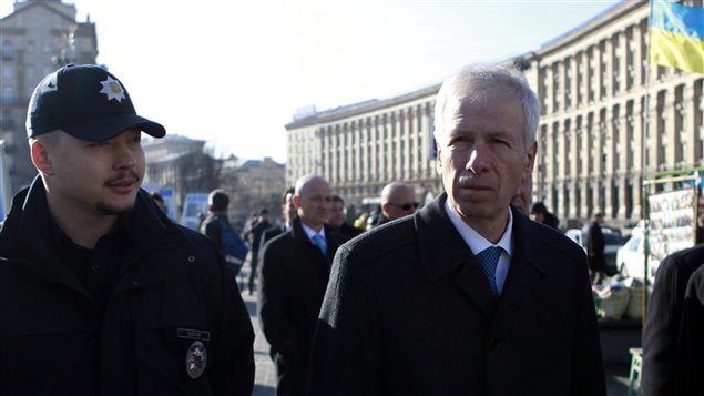  Canadian Foreign Affairs Minister Stephane Dion, right, walks on Independence Square in in Kiev, Ukraine, Monday, Feb. 1 2016. 