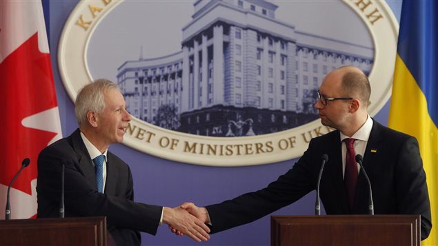  Canadian Foreign Affairs Minister Stephane Dion, left, and Ukraine’s Prime Minister Arseniy Yatsenyuk shake hands during a joint statement to the press in Kiev, Ukraine, Monday, Feb. 1 2016. 
