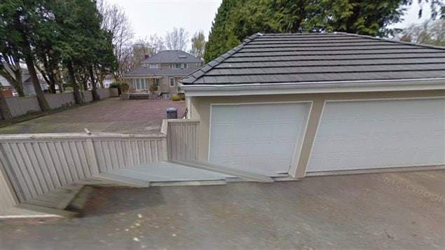 Rear view of the huge backyard with mature trees and 3-car garage, a renovated and nicely maintained $6 million *teardown* in Vancouver