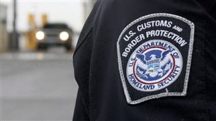  A U.S. Customs and Border Protection (CMP) officer stands near a security booth as vehicles approach in Detroit, Michigan, on June 1, 2009. 