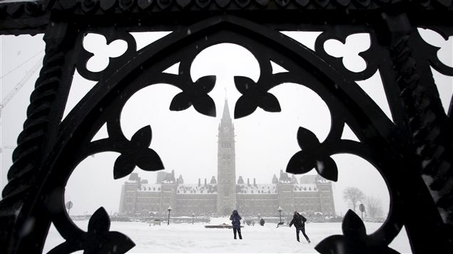 People walk on Parliament Hill during a snow storm in Ottawa, Canada, February 16, 2016.