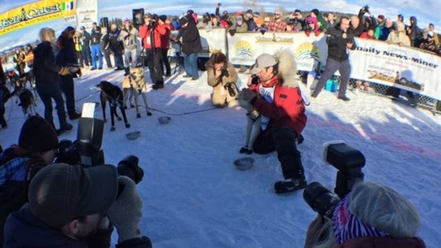 Alaskan Hugh Neff hugs one of his dogs at the finish of the 2016 Yukon Quest. This is his second win in 14 races