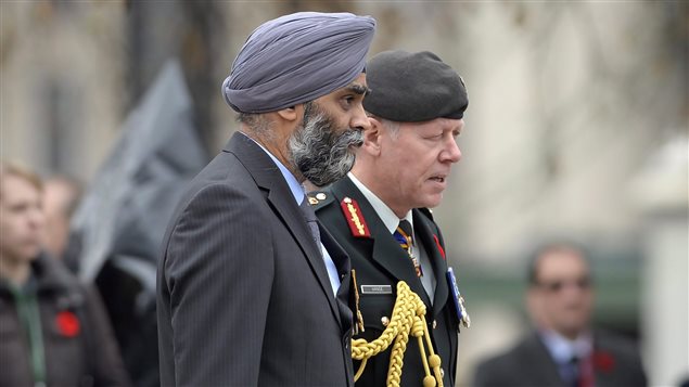  Defence Minister Harjit Singh Sajjan, left, and Chief of Defence Staff Gen. Jonathan Vance attend the Remembrance Day ceremony in Ottawa on Wednesday, Nov. 11, 2015. 