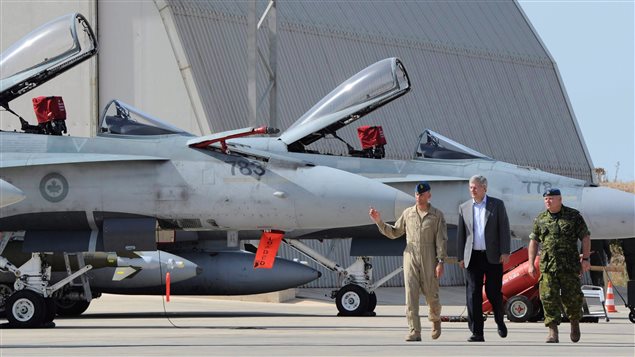  Prime Minister Stephen Harper, middle, gets a tour of Canada’s CF-18’s at Camp Fortin on the Trapani-Birgi Air Force Base in Trapani, Italy, on Thursday, September 1, 2011. 