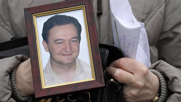 The U.S. law is named after lawyer Sergei Magnitsky who died in a Russian prison. The portrait is held by his mother on Nov. 30, 2009.