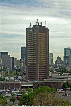 The Maison Radio-Canada in Montreal.View from the east, with loading bays, ground-level structures and parking area visible. RCI now occupies a small section in the below ground level B. As of 2016 the entire building is listed for sale.