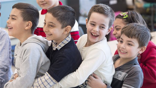  Syrian refugees Jamil Haddad, left, and Tony Batekh, 2nd left, George Louka and Edmon Artin, right, have some fun while they attend French classes at a school Wednesday, February 17, 2016 in Montreal.