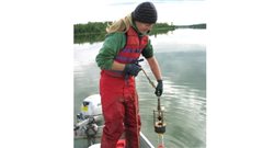 Diane Orihel collecting samples of sediment from Nakumun Lake, Alberta