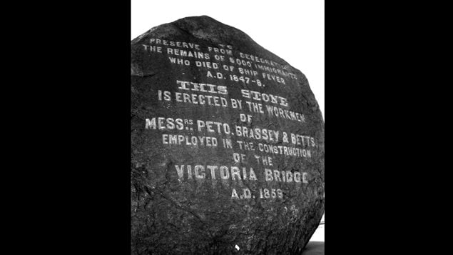 Workers (many of them Irish) building the Victoria Bridge in Montreal discovered remains of Irish immigrants who died of Typhus and other disease in *fever sheds*. and erected this  large black rock in 1859 near the bridge in their memory. Each year a group of Irish Montrealers stages a memorial walk to the monument to commemorat the lives lost.