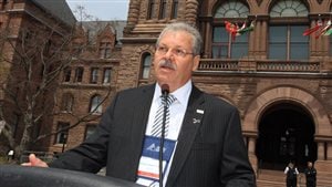 Shown speaking at Queen’s Park, Toronto (Ontario legislature) Warren (Smokey) Thomas, President of the Ontario Public Service Employees Union (OPSEU) is strongly opposed to privitization of public health care saying health care should be about people not profit