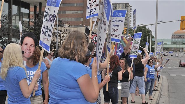 Health care workers in Kitchener Ontario protest contract negotiations Their T-shirts read *Patients before profits*