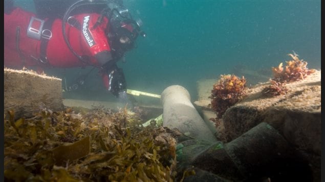 A Parks Canada diver swims over the HMS Erebus near one of the ship’s cannons.
