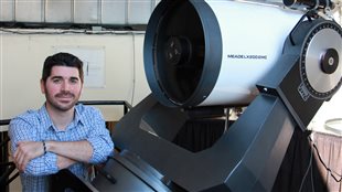 Jesse Rogerson, PhD candidate in astrophysics at York University stands by one of the university’s smaller telescopes. He led the international research which made the discovery 