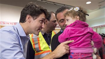 Canada’s Prime Minister Justin Tudeau (left) went to Montreal’s airport to welcome Syrian refugees soon after being elected in late 2015.