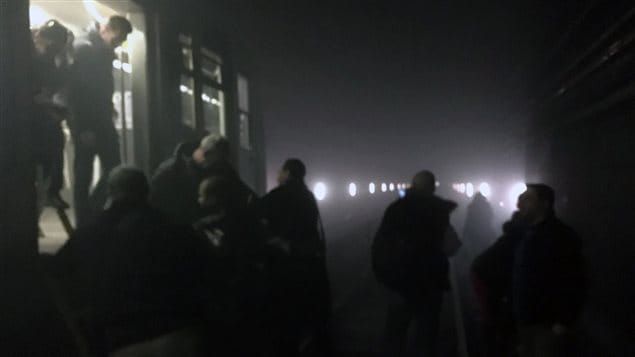  In this photo provided by EurActiv and photographed by Evan Lamos, passengers on the metro leave their carriages and walk along the tracks following an attack on the Brussels underground transport system in Brussels, Belgium, after an explosion, Tuesday, March 22, 2016. 