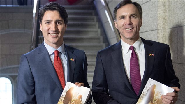  Prime Minister Justin Trudeau (left) walks with Minister of Finance Bill Morneau as he arrives to table the budget on Parliament Hill, Tuesday, March 22, 2016 in Ottawa.