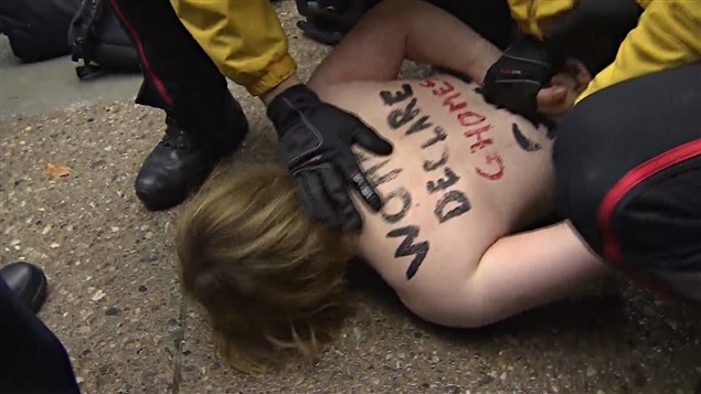 Une manifestante appartenant au groupe Femen dénonce l’acquitement de Jian Ghomeshi.