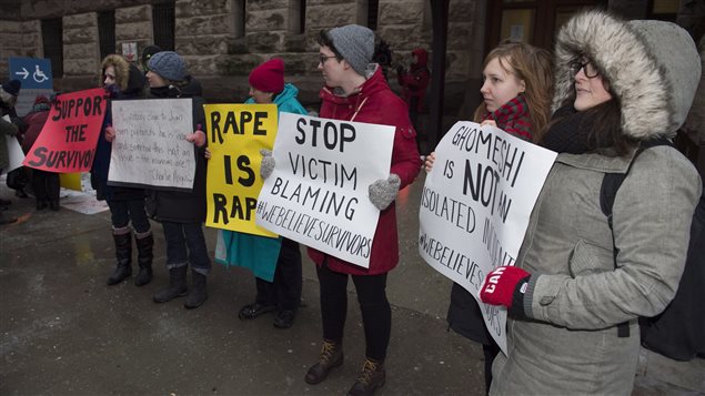  Protestors stand outside court in Toronto on Thursday, March 24, 2016.