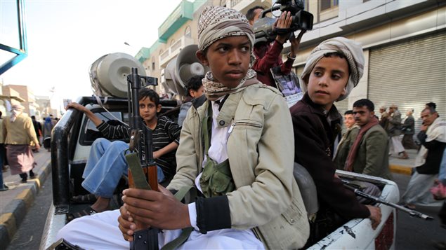  Boys who are part of the Houthi fighters, hold weapons as they ride on the back of a patrol truck during a demonstration to show support to the movement, and rejecting foreign interference in Yemen’s internal affairs, in Sanaa March 13, 2015. 
