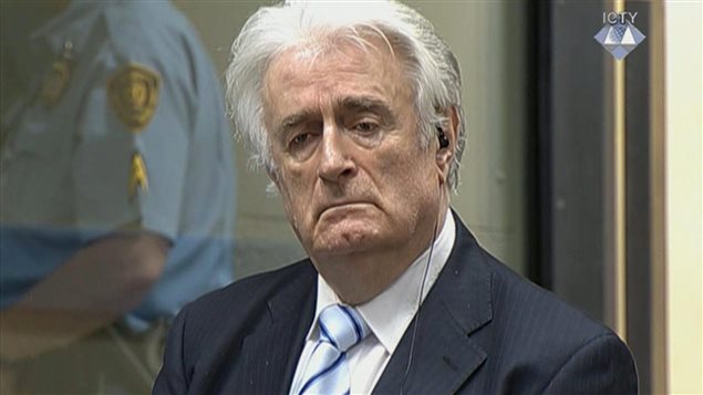  In this image taken from video Bosnian Serb wartime leader Radovan Karadzic listens to the verdict at the International Criminal Tribunal for Former Yugoslavia (ICTY) in The Hague, The Netherlands Thursday March 24, 2016. Karadzic was convicted of genocide and nine other charges Thursday at a U.N. court, and sentenced to 40 years in prison. (ICTY, Pool via AP)